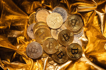 crypto coin and bitcoin on golden background,gold mining background