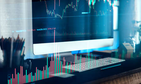 Working on a computer and graphing cryptocurrencies,finance background