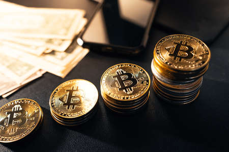 Stacked bitcoins grow on the desk ready to invest.