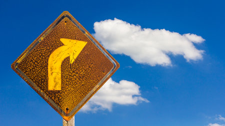 Close up the signs and turn right where the old rusty weathered a long time sky as a backdrop.の写真素材