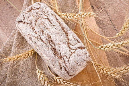 Bread rye spikelets on an wooden background