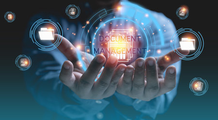 DOCUMENT MANAGEMENT SYSTEM. Technology digital internet online keep documents business for security. Businessman holding digital databases and corporate files and information on hands.の写真素材