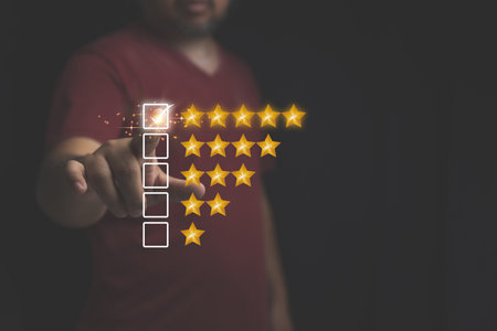 Customer review feedback survey, satisfaction ranking high. A man give rating to service experience on online application. Customer can evaluate of service leading to reputation ranking of business.の写真素材