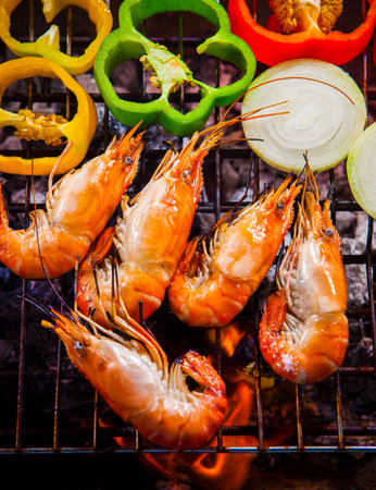 shrimp,prawns grilled on barbecue fire stove with chilly onion for seafood mealの写真素材