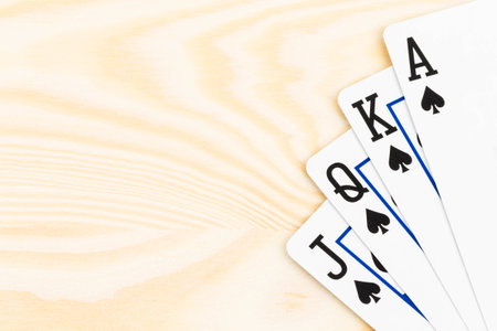 Royal flush poker playing cards on wooden background