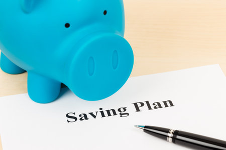 Saving plan with pen and piggy bankの写真素材