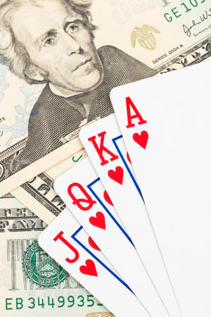 Royal flush poker playing cards on dollar banknote