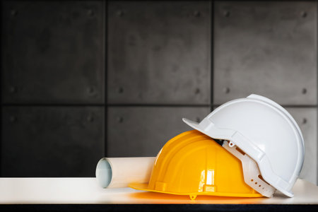 Construction house and building. Repair work. Drawings for building and helmet on white table.