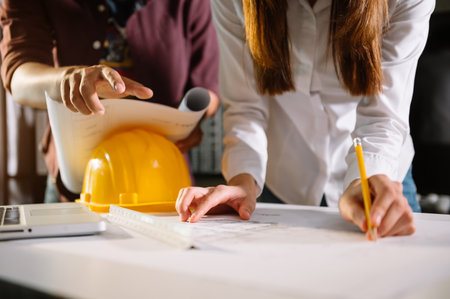 Image of engineer meeting for architectural project. working with partner and engineering tools on...