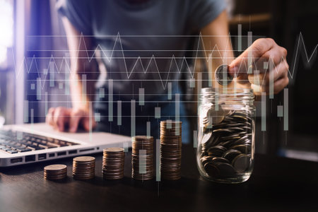 saving money with hand putting coins in jug glass and calculator to calculate budget concept finance...