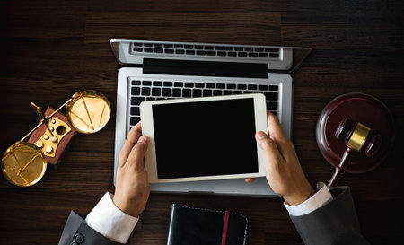 Justice and law concept.Lawyer workplace with laptop and documents with notepad,smartphome. top viewの写真素材