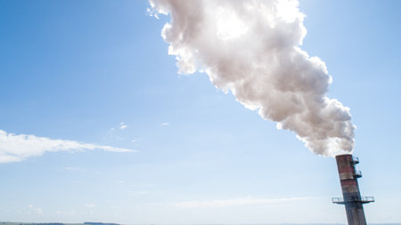 Air pollution from power plant chimney. Dirty smoke on the sky, ecology problems.の写真素材