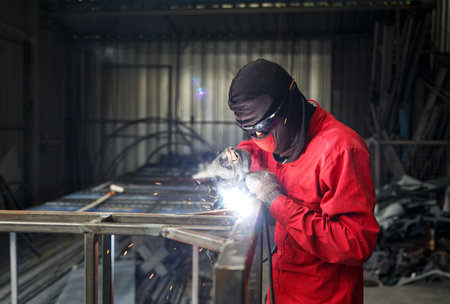 Industrial Worker at the factory welding closeup