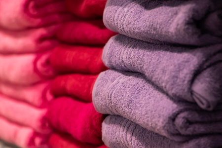 A stack of multi-colored bath towels close-up. Spa accessories for health care.の写真素材