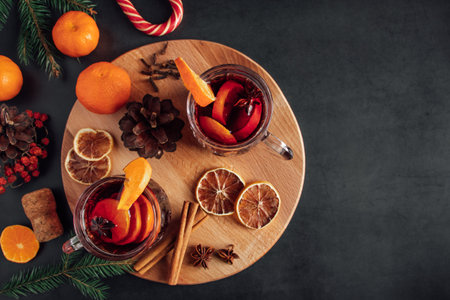 Hot mulled wine in a glass cup. Warm winter drink with spices and fruits.の写真素材