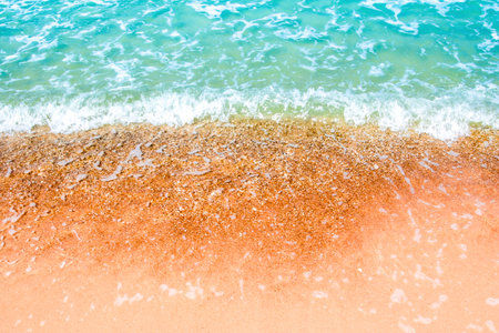 Bubble and clear water of sea and wave on the beachの写真素材
