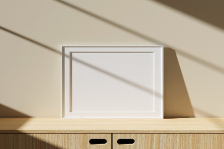 Horizontal white poster or photo frame mockup on table in living room interior with window shadow. 3D rendering.の写真素材