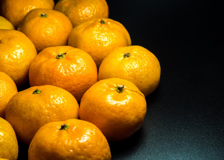 Close-up on glossy surface of freshness orange fruitsの写真素材