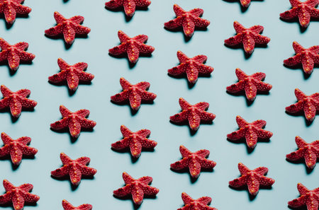 Pattern of starfish over a pastel blue background, minimalism, design and digital resource, background with copy spaceの写真素材