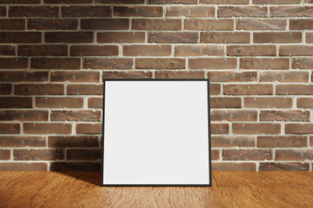 Square black poster or photo frame mockup on the wooden table with blurry brick background