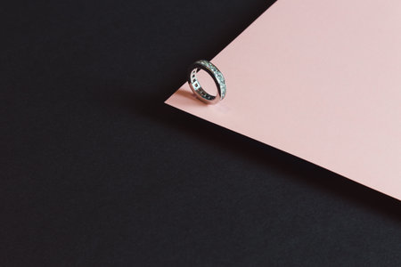 A diamond ring minimalistic shot over a pink and black backgroundの写真素材
