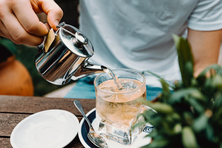 A young male preparing a tea in a modern bar