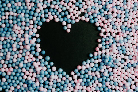 A black heart in the middle of pink and blue balloons love and equality concepts backgroundの写真素材