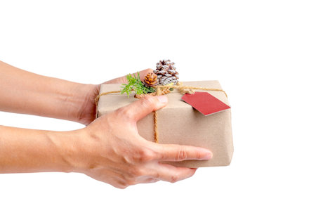 Close up woman hand holding Christmas present box isolated on white background,Gift giving on holiday seasonal concept.の写真素材