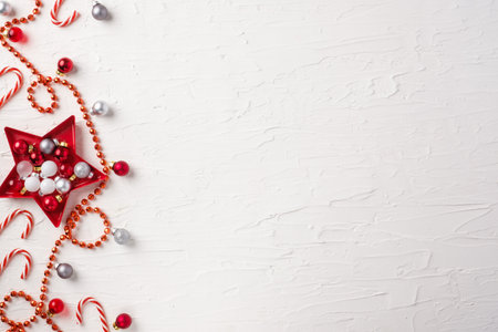 Christmas ball and tinsel and star decoration ornament on white concrete table backgroundの写真素材