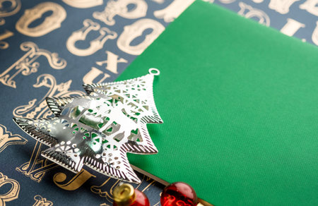 Christmas tree decoration with green notebook on old type pattern background.holiday greeting card...