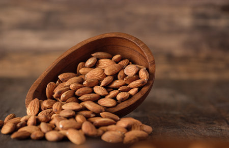 Almonds in wood bowl on wood table.Diet raw materialの写真素材