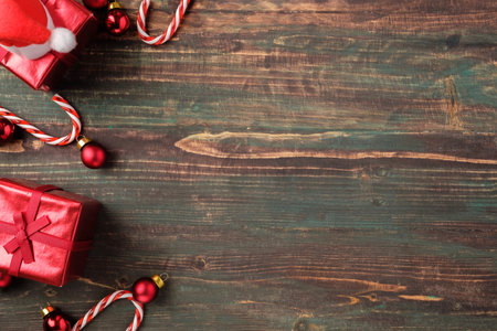 Christmas red bauble, gift box,candy cane decoration on table wood backgroundの写真素材