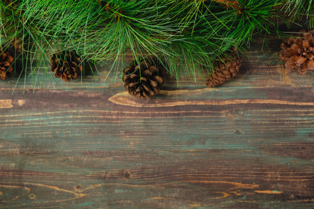 Christmas pine tree fir with pine cone decoration on vintage rustic wood table backgroundの写真素材