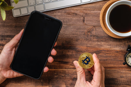 hand holding mobile and  bitcoin crypto currency to trading in stock market.defi on blockchain
