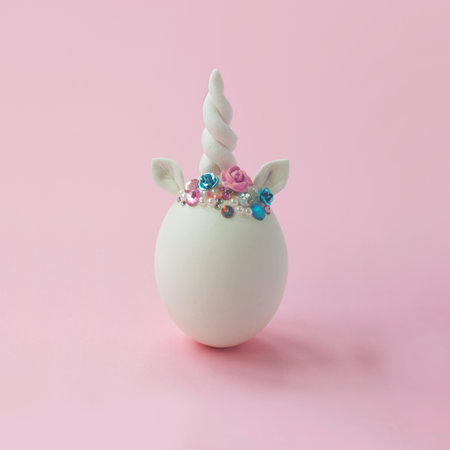 Single white egg, with unicorn decoration; Creative minimal Easter backgroundの写真素材