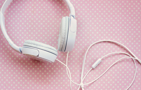 White headphones on pink backgroundの写真素材