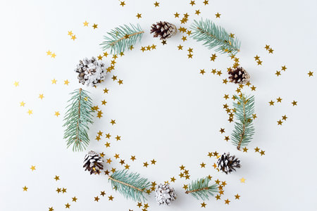 Christmas decorations round frame made of pine cones and fir tree branches on white background, top view. Flat lay Christmas backgroundの写真素材