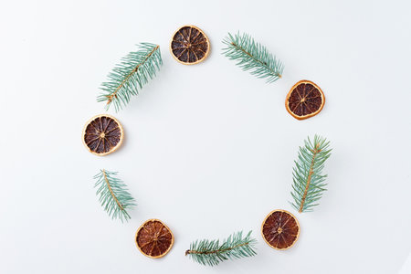 Christmas decorations round frame made of pine cones and fir tree branches on white background, top view. Flat lay Christmas backgroundの写真素材