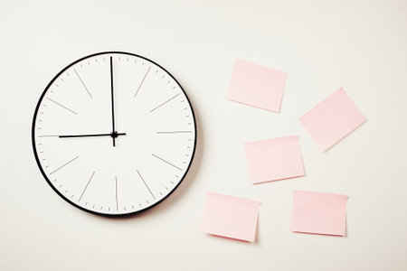 Wall clock and pink stickers on white background. Workspace mock up