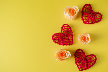 Red hearts and flowers on a yellow background, design postcard for Valentine's Day. Place for your text.の写真素材