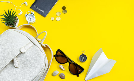 Summer travel concept. Traveler's accessories. Passport, money, sunglasses on a yellow background....
