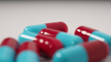 Taking or holding medication pills in hand. Capsule pill on white background isolated. Nitrile...