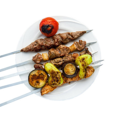 Kebab on skewers in a plate on a white background.  Top view. Isolated. Barbecueの写真素材