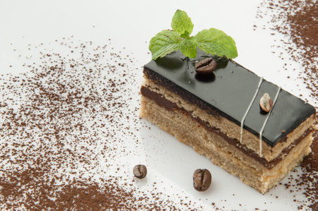 a piece of cake with sprinkled with powdered sugar on a white backgroundの写真素材