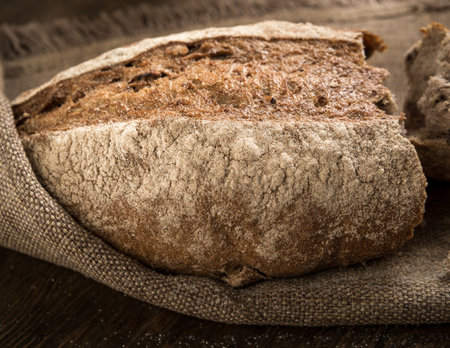 closeup of a broken loaf of bread on a cloth napkinの写真素材