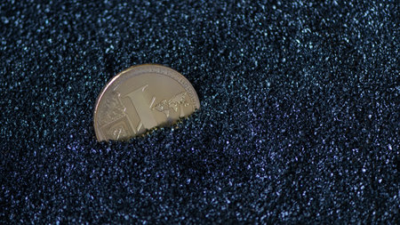 litecoin on blue sparkling granules, sand. electronic moneyの写真素材