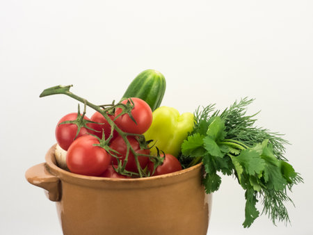 different fresh vegetables in ceramic bowl on white backgroundの写真素材