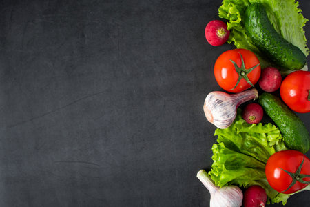 Fresh raw vegetables on a dark background. The concept of healthy eating and vegetarianism. Place for text.の写真素材