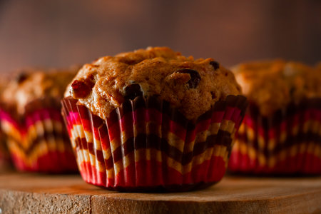 Homemade raisin cupcakes. Traditional autumn pastries on a wooden background.の写真素材