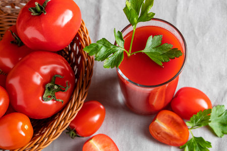 Fresh tomato juice on a wooden rustic background. Organic vegetable drink with parsley.の写真素材